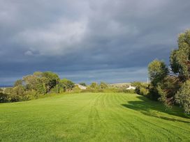 A green field with trees and clouds in the sky at 3Bed Cottage Plymouth Dog friendly Sleeps7