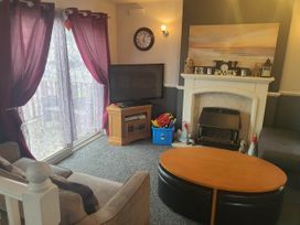 A living room with a sofa and television at the property in Fleetwood