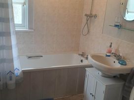 A bathroom with a bathtub and sink at The Old Barn in Fleetwood