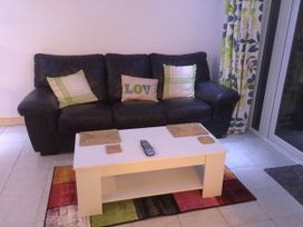 A living room with a sofa and coffee table at Tanygrisiau near Blaenau Ffestiniog