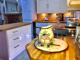 A kitchen with various appliances and a decorative pitcher at Tanygrisiau near Blaenau Ffestiniog