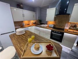 A kitchen with pancakes and strawberries on a tray at Tanygrisiau near Blaenau Ffestiniog