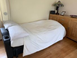 A bedroom with a bed and furniture at Tanygrisiau near Blaenau Ffestiniog