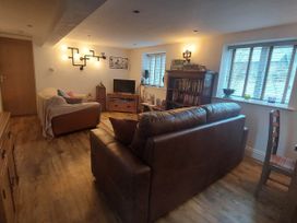 A living room with a sofa and bookshelf at the property in Hawkshead
