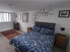 A bedroom with a bed and bedside table at The Old Barn in Hawkshead
