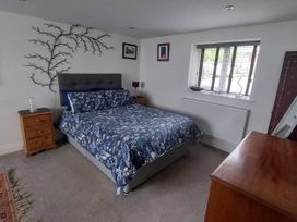A bedroom with a bed and bedside table at the property in Hawkshead
