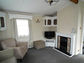 A living room with an armchair and television at 