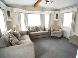 A living room with a sofa and armchair at The Old Barn in Manchester