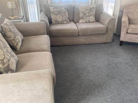 A living room with a sofa and armchair at the property located in 