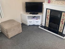 A living room with a television and fireplace