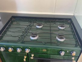 A gas stove with burners and control knobs at 