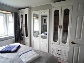 A bedroom with a bed and wardrobes at The Old Barn in Manchester