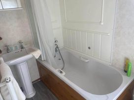 A bathroom with a bathtub and sink at 