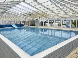 An indoor swimming pool with a slide at a leisure facility in an unspecified location