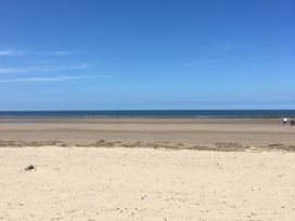 A beach with sand and ocean at a seaside location