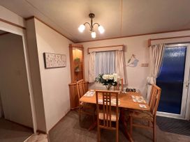A dining room with a table and chairs at The Old Barn Near West Mersea