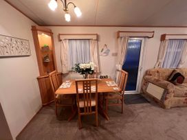 A dining room with a table and chairs at The Old Barn Near West Mersea