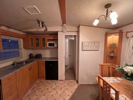 A kitchen with wooden cabinets and a dining area at 