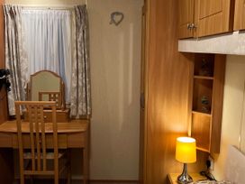 A bedroom with a dressing table and lamp at 