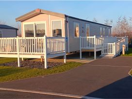 A mobile home with a deck and ramp at property near Flookburgh