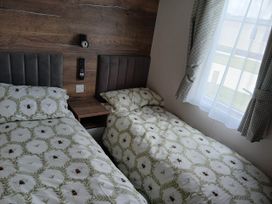 A bedroom with two beds and a window at 