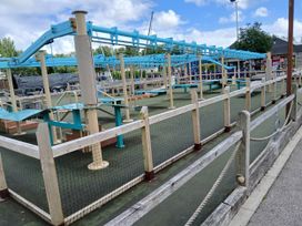 A play area with safety netting and railings at a recreation area near Flookburgh
