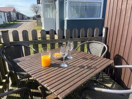 A table with drinks and snacks in an outdoor seating area at the property in Bridlington