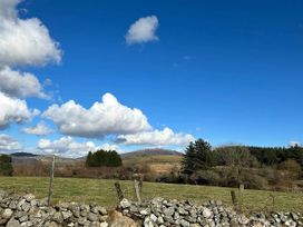 A landscape with clouds and hills at the property location near Penygroes