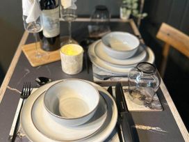 A dining table set with tableware at a property in Newton Abbot