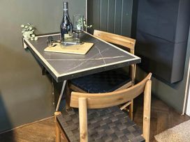 A dining table with wine and glasses at a property in Newton Abbot