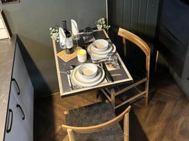 A dining room with a table set for two at The Old Barn in Newton Abbot