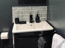 A sink with faucet and soap dispenser at the property in Newton Abbot