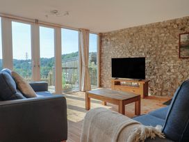 A living room with a sofa and television at The Linhay Cotleigh Nr. Honiton