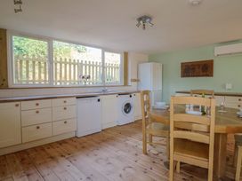A kitchen with a table and chairs at The Linhay Cotleigh Nr. Honiton