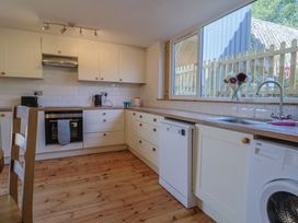 A kitchen with appliances and a window at The Linhay in Cotleigh Nr. Honiton
