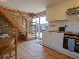 A kitchen with a staircase and dining area at The Linhay Cotleigh Nr. Honiton