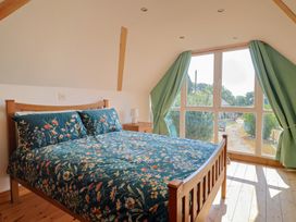 A bedroom with a bed and window at The Linhay Cotleigh Nr. Honiton