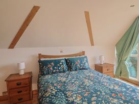 A bedroom with a bed and nightstands at The Linhay Cotleigh Nr. Honiton