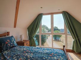A bedroom with a bed and a window at The Linhay in Cotleigh Nr. Honiton