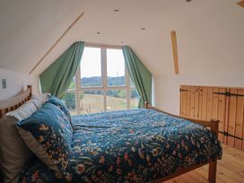 A bedroom with a bed and window at The Linhay Cotleigh Nr. Honiton
