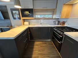 A kitchen with a sink and stove at Rockley Park in Poole