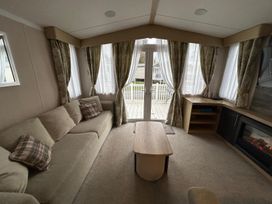 A living room with a sofa and a coffee table at Rockley Park in Poole
