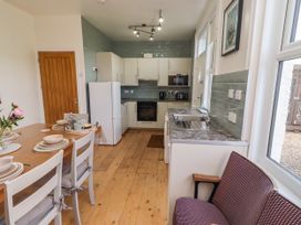 A kitchen with a table and chairs at Farnecrest in Seahouses