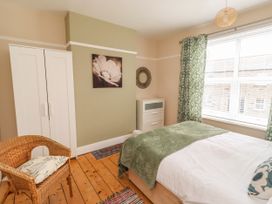 A bedroom with a bed and wardrobe at Farnecrest in Seahouses