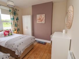 A bedroom with a bed and wardrobe at Farnecrest in Seahouses