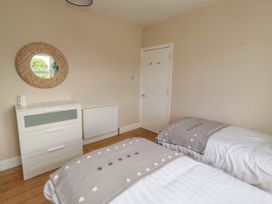 A bedroom with two beds and a dresser at Farnecrest in Seahouses