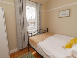 A bedroom with a bed and window at Farnecrest in Seahouses