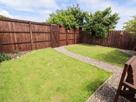 A garden with grass and gravel path at Farnecrest Seahouses