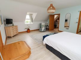 A bedroom with a bed and dresser at Alma House in Seahouses
