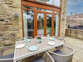 An outdoor dining area with a table and chairs at Alma House in Seahouses